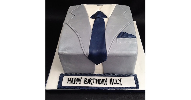 Vertical shot of a bow tie suit designed cake against a blurred background  Stock Photo - Alamy