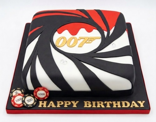 Square 007 James Bond theme birthday cake with black, white, red, and gold decorations, poker chips, and "Happy Birthday" message.