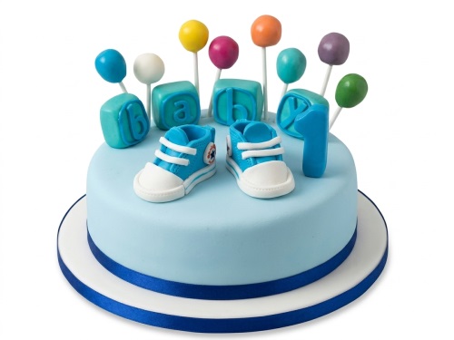 Light blue 1st birthday cake for boys with blue baby sneakers, alphabet blocks, and colourful cake pops.