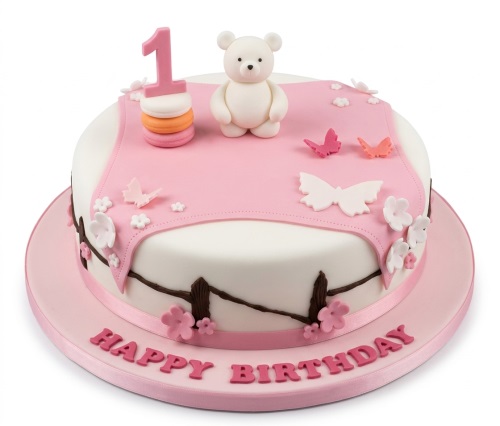 White and pink round birthday cake with a teddy bear, butterflies, flowers, and a custom age topper.