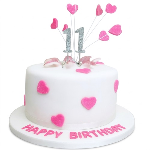 White round birthday cake with pink glitter hearts and a silver custom age topper.