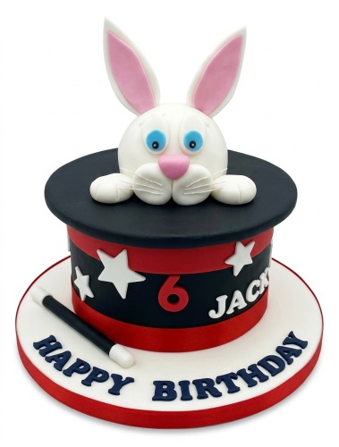 Round birthday cake with a 3D rabbit in a magic hat, white stars, and a magic wand.