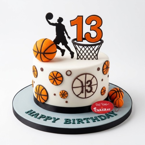 White birthday cake with a basketball player, hoop, 3D basketballs, and a custom age topper.