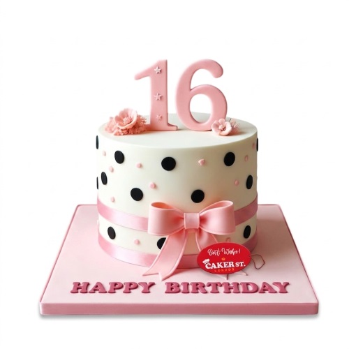 White birthday cake with black and pink polka dots, pink ribbon, bow, sugar flowers, and a pink custom age topper.