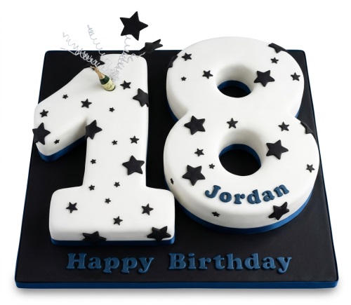 White number-shaped birthday cake with black stars, blue trim, and a champagne bottle topper on a black board.