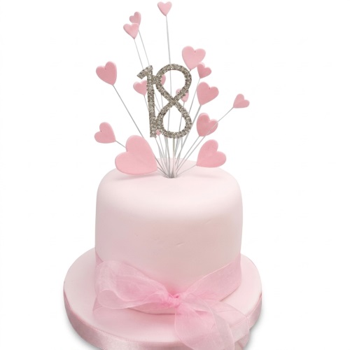 Pink single-tier birthday cake with pink heart toppers and a glitter custom age number.