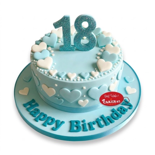 Round light blue birthday cake with white and blue fondant hearts, white pearls, and a glitter custom age topper.