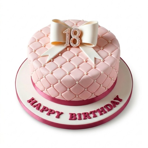 Pink quilted birthday cake with white bow, pearl details, and custom age topper.