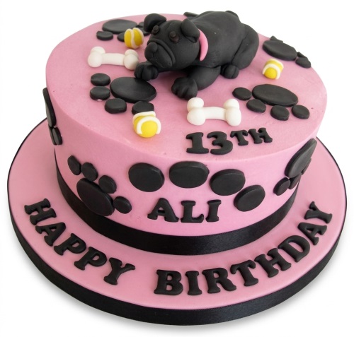 Pink birthday cake with black pug dog, paw prints, bones, tennis balls, and custom age.