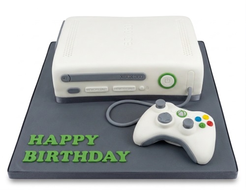 White Xbox 360 console cake with controller and 'Happy Birthday' message.
