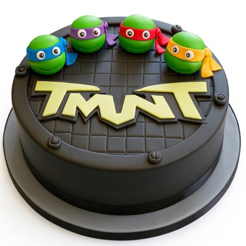Round black cake with green Teenage Mutant Ninja Turtles heads and yellow TMNT logo.