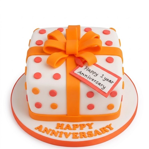 White square anniversary cake with orange ribbon, bow, polka dots, and custom message tag.