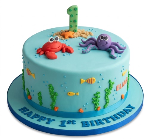 Round blue Under the Sea 1st Birthday Cake with crab, octopus, fish, and a number '1' topper.