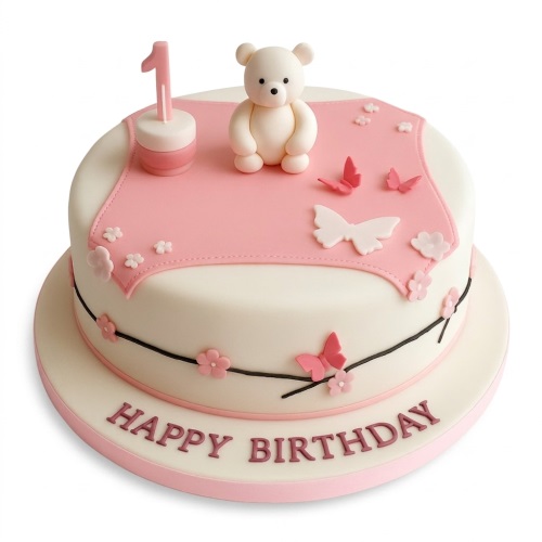 Round white and pink 1st birthday cake with a teddy bear, butterflies, and "Happy Birthday" text.