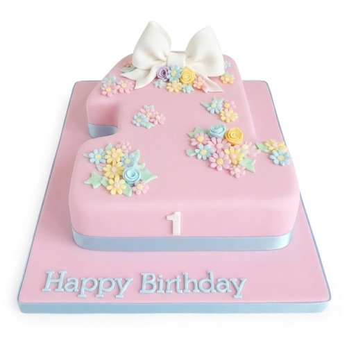 Pink number one 1st birthday cake for a girl, decorated with pastel sugar flowers and a white bow.