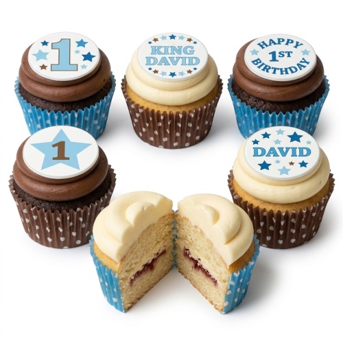 A selection of 1st birthday cupcakes for boys with blue and white star toppers, some showing the number 1 and example names.