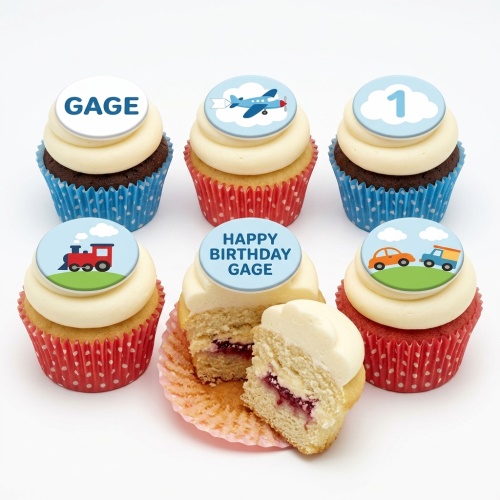Cupcakes with blue and red polka dot cases, topped with cream frosting and edible transport-themed discs featuring a train, airplane, car, and truck, plus examples of a custom age '1' and personalised name 'GAGE'.