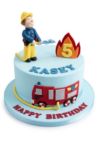 Light blue round cake with a 3D fireman figure, red fire engine, and a fire decoration with a custom age number.