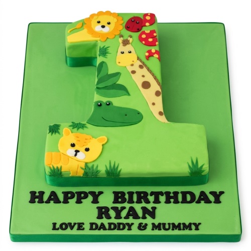 Number one shaped jungle theme 1st birthday cake with lion, giraffe, crocodile, and tiger decorations.