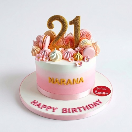 Pink ombre birthday cake with gold custom age topper, macarons, meringues, and sugar flowers.