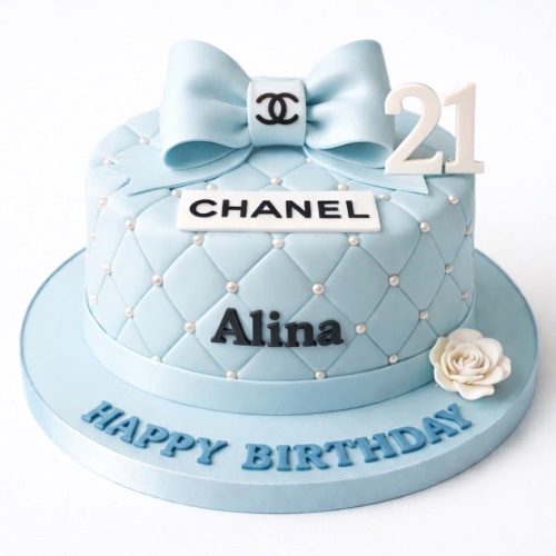 Light blue Chanel-inspired birthday cake with quilted pattern, pearl details, a large bow, and a white rose.