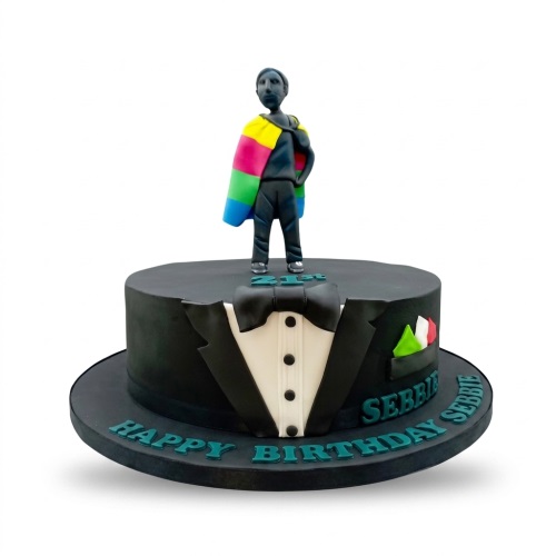 Black tuxedo birthday cake with a man in a rainbow cape and custom age topper.