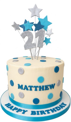 Round cream birthday cake with blue and silver polka dots, star toppers, and a custom age topper.