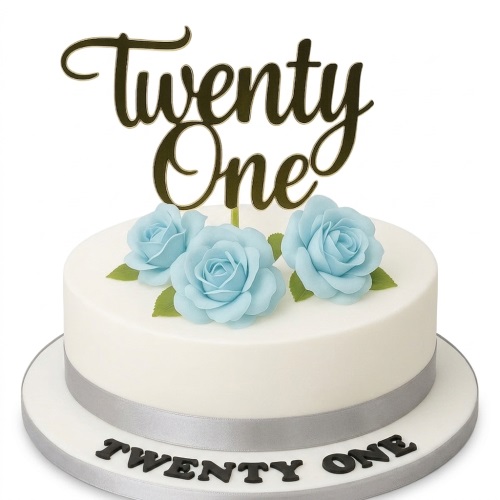White birthday cake with blue sugar roses, silver ribbon, and a gold custom age topper.