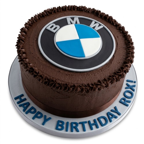 Round chocolate cake with edible BMW logo and 'Happy Birthday' message on cake board.