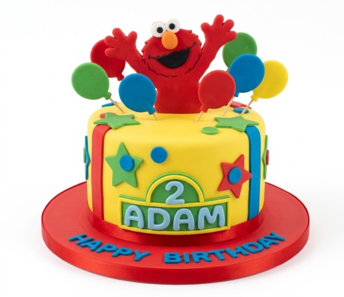 Yellow Elmo birthday cake with colourful balloons, stars, and custom age and name plaques.
