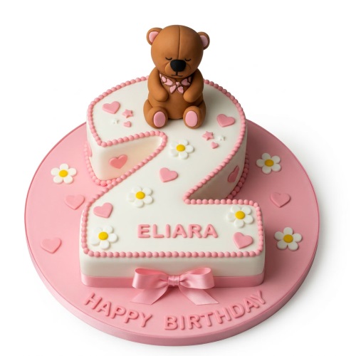 Pink and white number 2 cake with teddy bear, daisies, and personalised name.