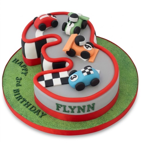 Racing car themed birthday cake shaped like a number, with fondant cars and a race track design.
