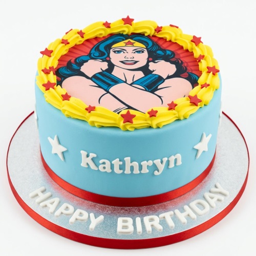 Round blue Wonder Woman birthday cake with edible image, yellow swirls, red stars, and personalised name.