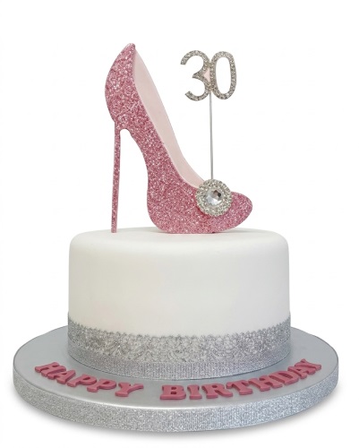 White round birthday cake with pink glitter high heel shoe topper, custom age topper, silver trim, and "Happy Birthday" text.