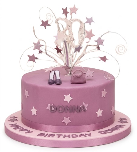Purple round birthday cake with a custom age topper, stars, miniature high heels, and a handbag.