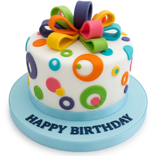 White birthday cake with colourful polka dots and a multi-coloured gift bow on a blue board with "Happy Birthday".