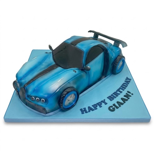 3D blue sports car birthday cake with black racing stripes on a light blue board.