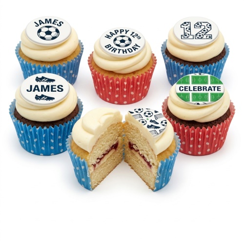 A selection of football-themed birthday cupcakes with white frosting, some with football, boot, and pitch toppers, in blue and red cases. One cupcake is cut to show jam filling.
