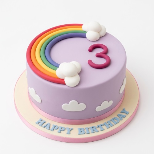 Round lavender cake with a rainbow, white clouds, and a custom age topper.