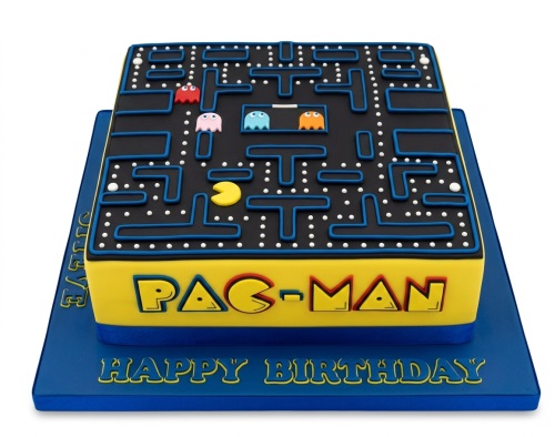 Square Pac-Man birthday cake with maze, Pac-Man, and ghosts on a blue board.