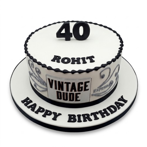 White round birthday cake with black number 40 topper, 'Vintage Dude' plaque, and black 'Happy Birthday' message.