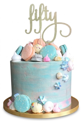 Pastel blue and pink birthday cake with macarons, meringues, cake pops, and custom age topper.
