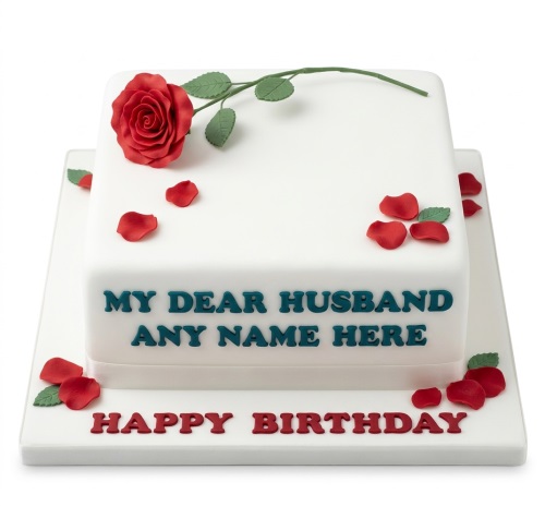 White square birthday cake with a red rose, green stem, and scattered petals. Personalised message.