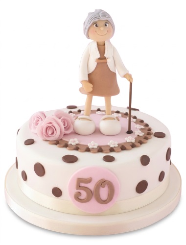 Round white birthday cake with senior woman figurine, pink roses, and brown polka dots.