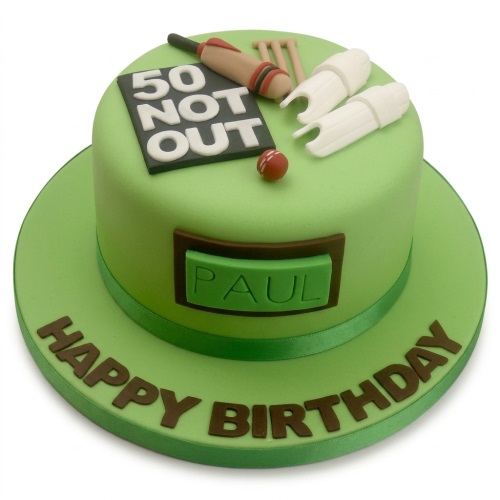 Green fondant cricket birthday cake with "50 Not Out" scoreboard, bat, ball, wickets, and personalised name.