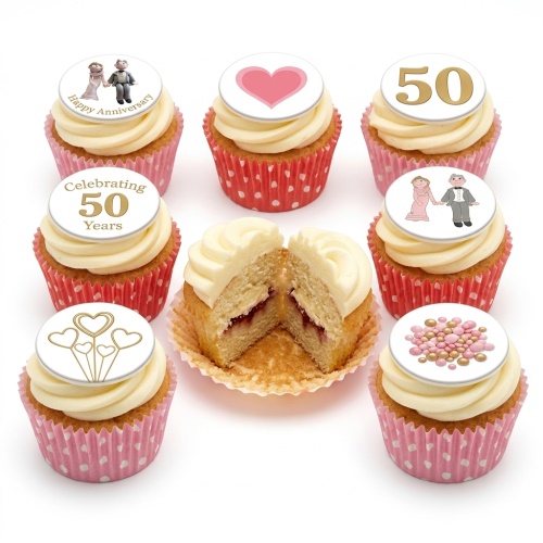 Set of 50th Anniversary cupcakes with gold '50', couple, and heart toppers, in pink and red cases.