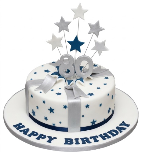 White round birthday cake with blue stars, silver ribbon, and custom age topper with star decorations.