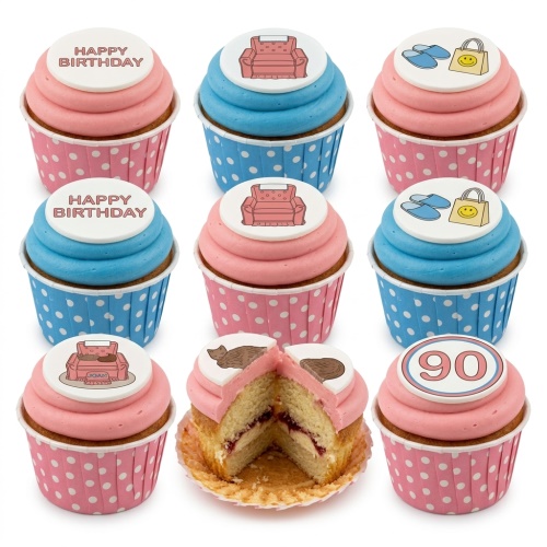 Collection of pink and blue cupcakes with comfort-themed toppers including a sofa, slippers, cat, and a custom age topper.