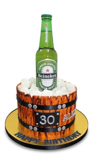 Heineken beer bottle cake in a wooden barrel design with ice and a custom age plaque.