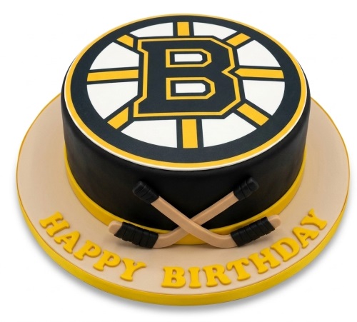 Round black and yellow Boston Bruins ice hockey birthday cake with crossed hockey sticks and 'Happy Birthday' message.